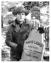 Johnny placing the former marshal's headstone