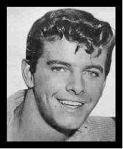 Peter Brown in one of several hairstyles sported as Johnny McKay