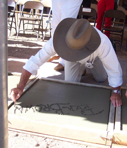 Peter writes his name in the cement